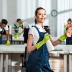 photodune-priP4aGR-happy-cleaner-holding-detergent-spray-and-rag-while-standing-near-multicultural-colleagues-and-xxl